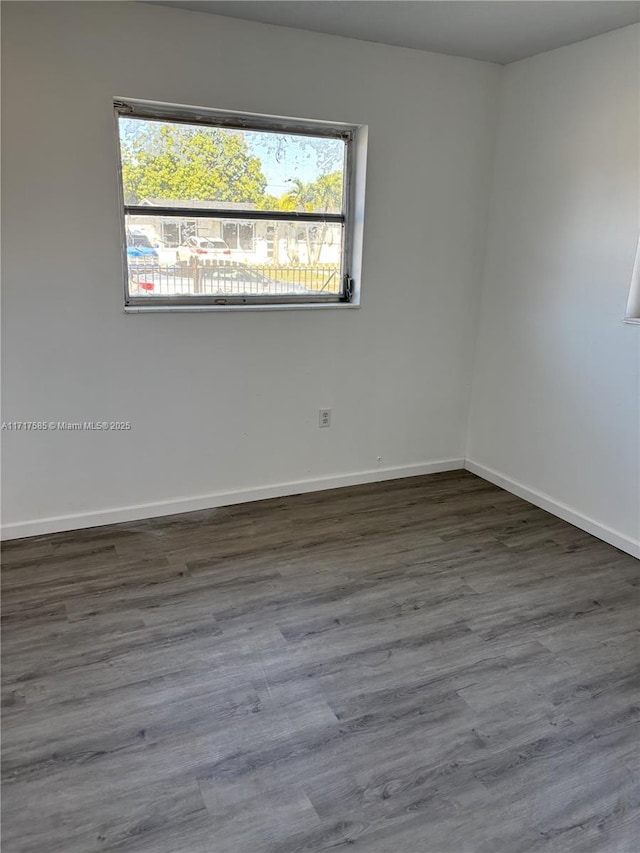 spare room with dark hardwood / wood-style floors