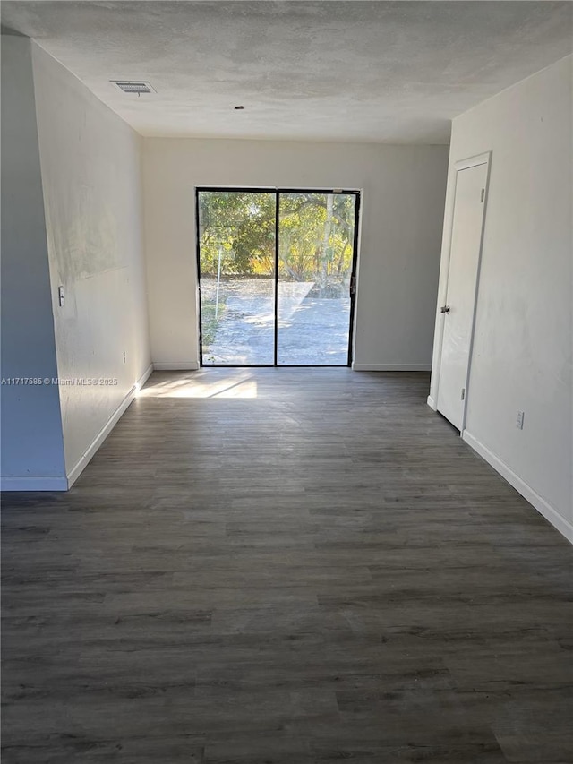 empty room featuring dark hardwood / wood-style floors