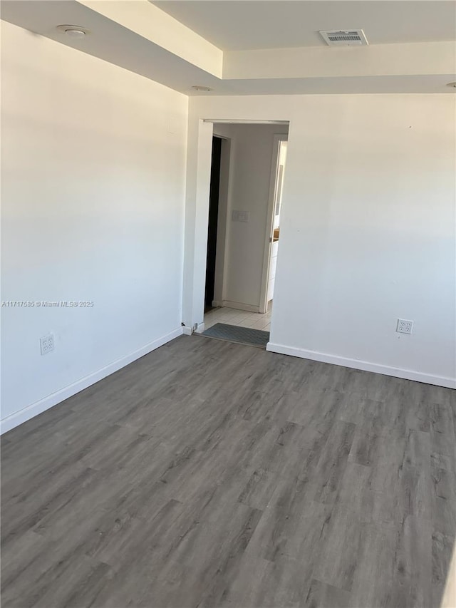 unfurnished room with hardwood / wood-style flooring