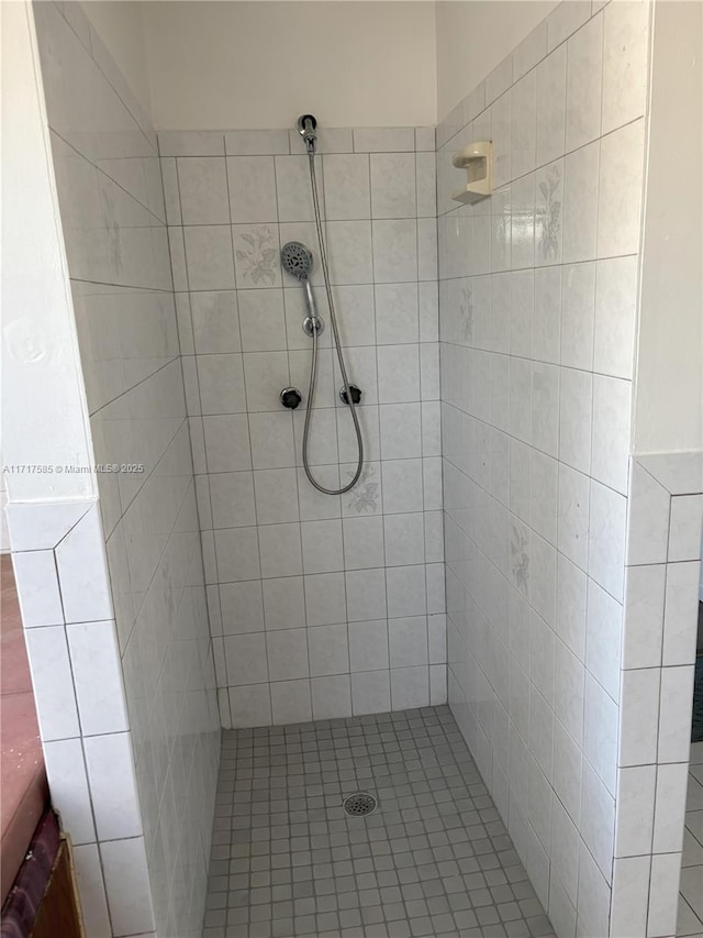 bathroom with tiled shower