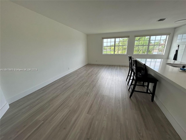 unfurnished dining area featuring dark hardwood / wood-style flooring