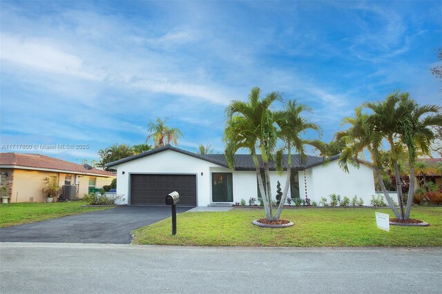 ranch-style home with a garage and a front yard