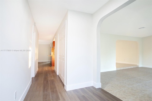 hall with hardwood / wood-style floors