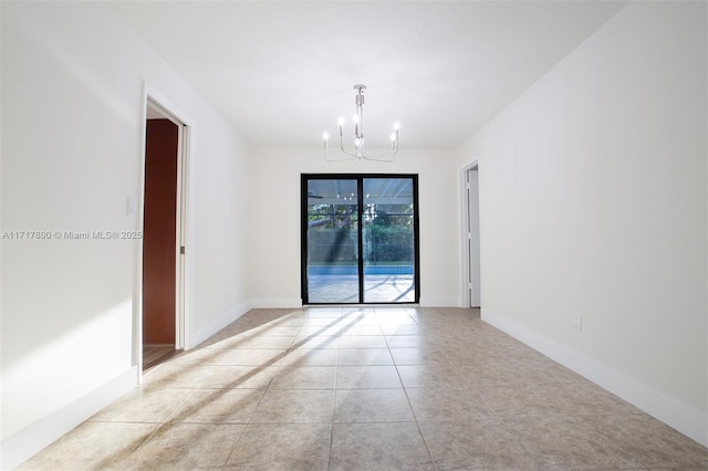 unfurnished room featuring an inviting chandelier