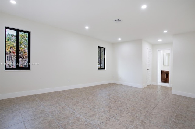 unfurnished room featuring light tile patterned floors, baseboards, and recessed lighting