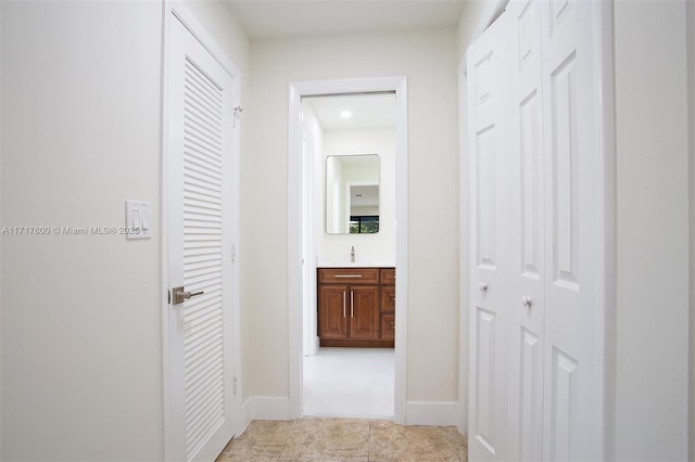 corridor featuring light tile patterned floors