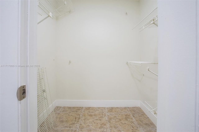 spacious closet featuring tile patterned flooring