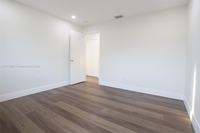 empty room featuring dark hardwood / wood-style flooring