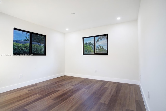 unfurnished room with baseboards, recessed lighting, and wood finished floors