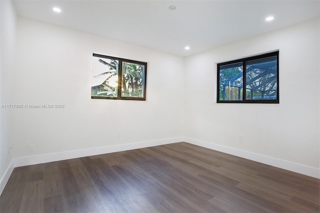 unfurnished room featuring wood finished floors, baseboards, and recessed lighting