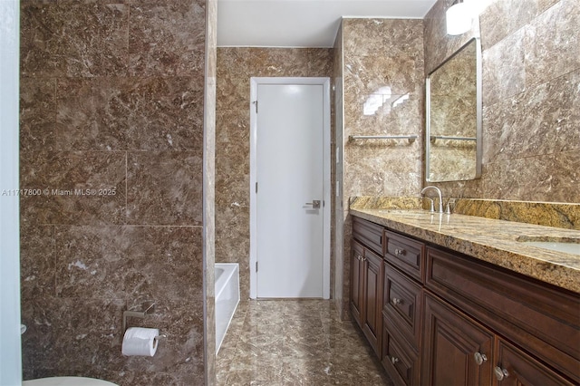 full bathroom featuring a sink, toilet, double vanity, and a bathing tub