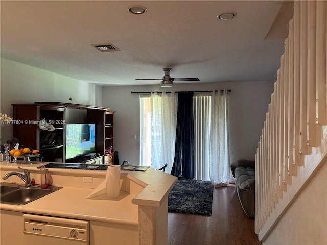 kitchen with a textured ceiling, ceiling fan, sink, hardwood / wood-style flooring, and dishwasher