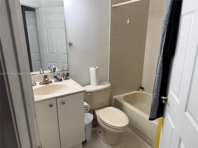 full bathroom featuring tile patterned flooring, vanity, toilet, and tiled shower / bath