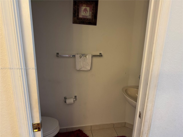 bathroom with tile patterned flooring and toilet