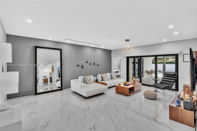 living room featuring a chandelier and french doors