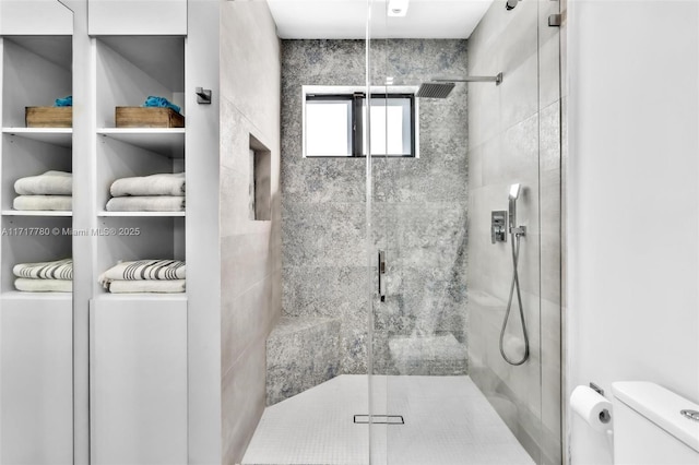 bathroom with toilet and walk in shower