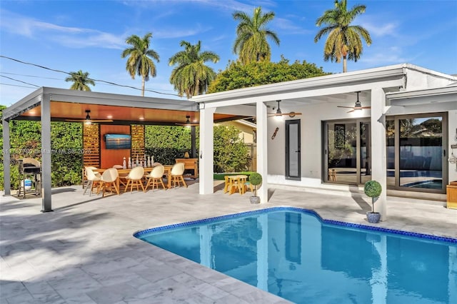 view of pool featuring a patio and ceiling fan