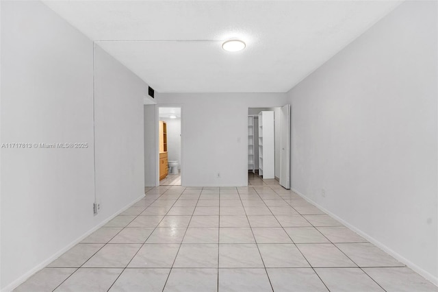 empty room with light tile patterned floors