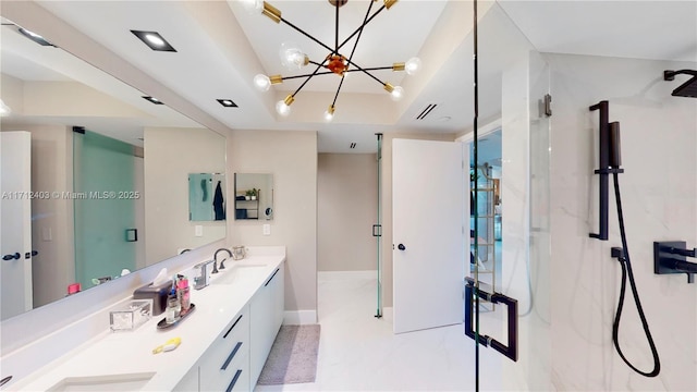 bathroom featuring vanity, a raised ceiling, a shower with shower door, and a chandelier