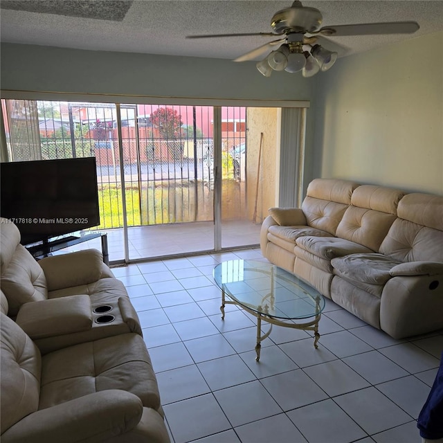 tiled living room with ceiling fan and a textured ceiling