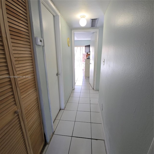 corridor featuring light tile patterned floors