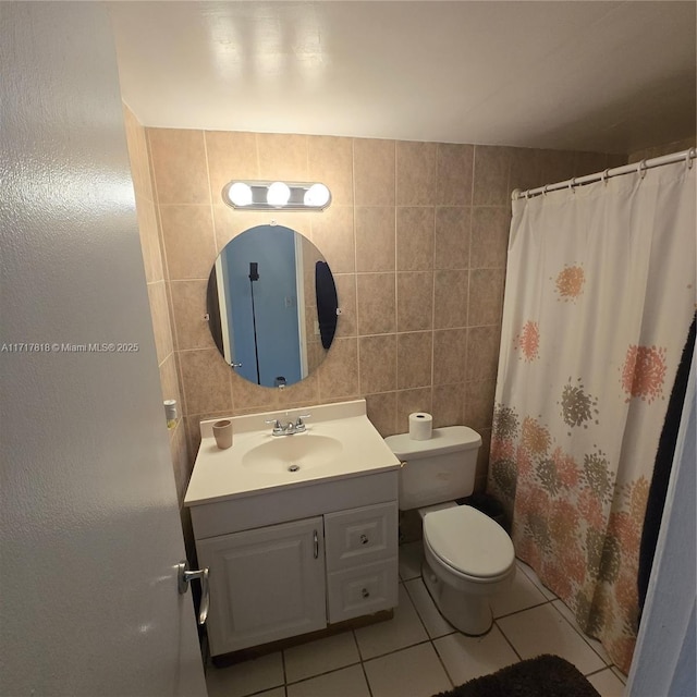 bathroom with tile patterned floors, a shower with curtain, vanity, tile walls, and toilet