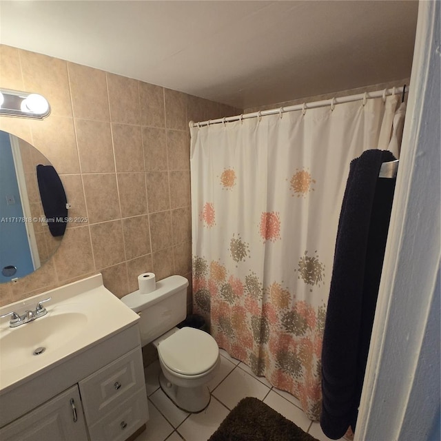 bathroom with a shower with shower curtain, tile patterned floors, vanity, tile walls, and toilet