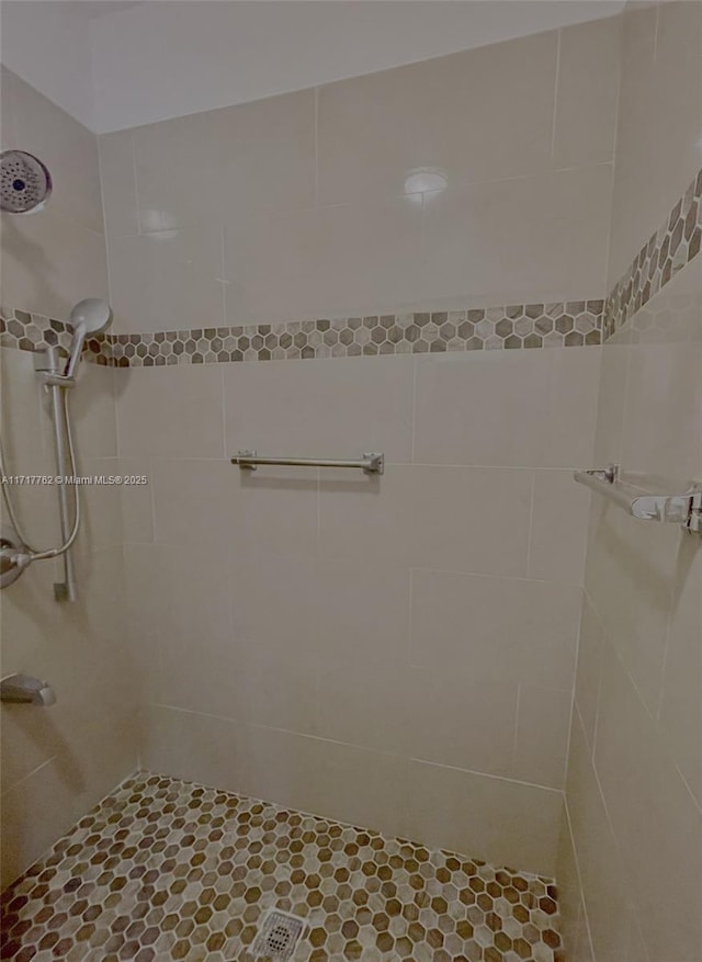 bathroom with tiled shower