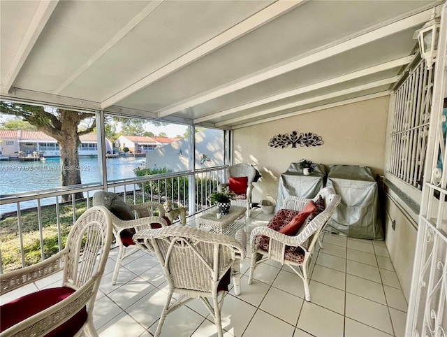 sunroom / solarium featuring a water view