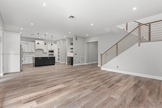 unfurnished living room with light hardwood / wood-style flooring