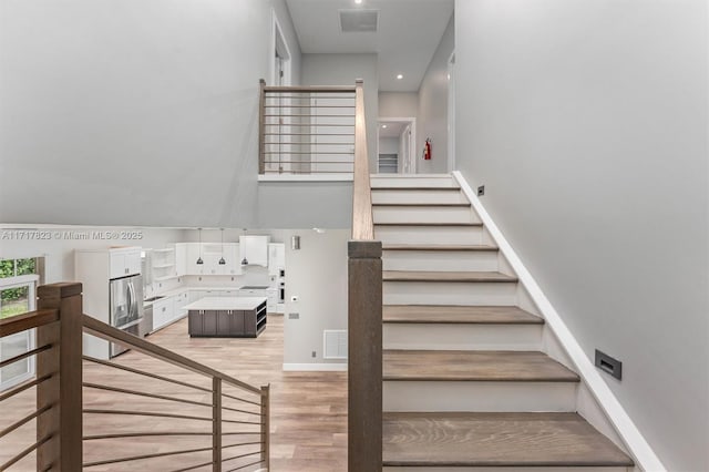 staircase featuring hardwood / wood-style flooring