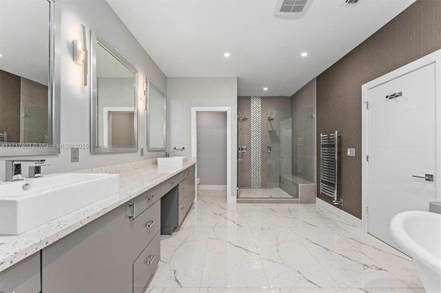 bathroom with radiator heating unit, vanity, toilet, and a shower with door