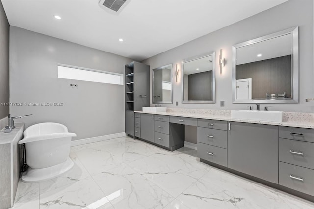 bathroom with vanity and a bath