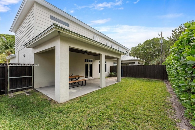 rear view of property with a patio area and a yard