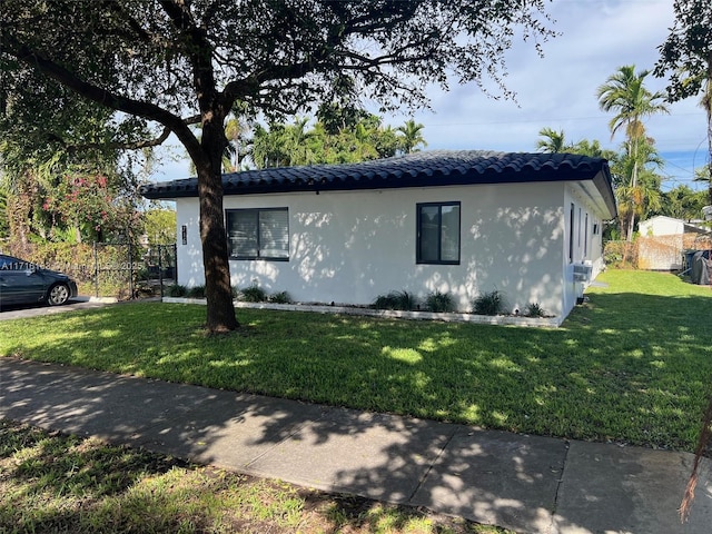 view of side of home featuring a lawn