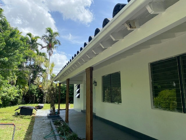 view of side of home featuring a lawn