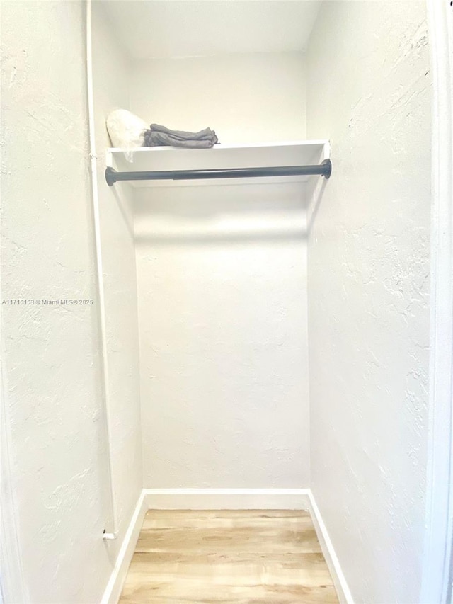 spacious closet featuring hardwood / wood-style floors