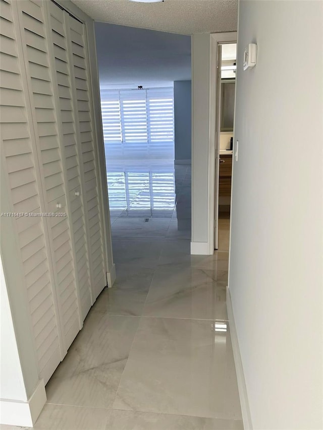 hallway featuring a textured ceiling