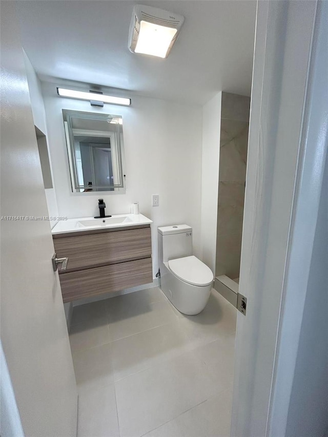 bathroom featuring tile patterned flooring, vanity, and toilet