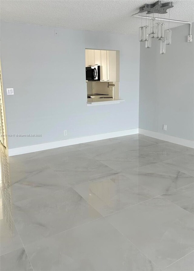 empty room featuring a textured ceiling and dark wood-type flooring