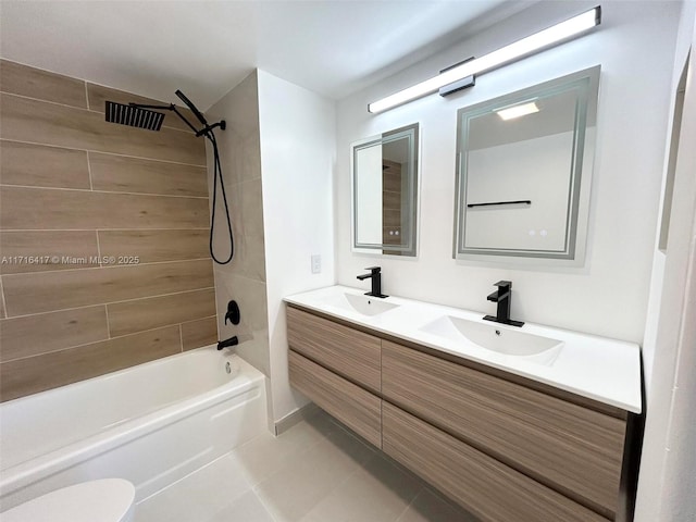 full bathroom with tile patterned flooring, tiled shower / bath combo, toilet, and vanity