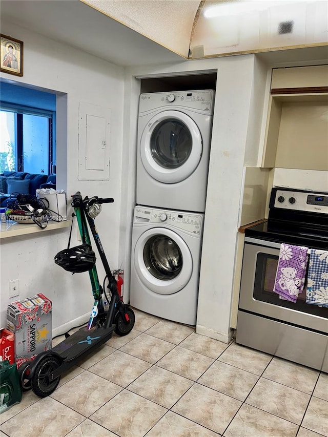 laundry room featuring light tile patterned floors, electric panel, and stacked washer and dryer