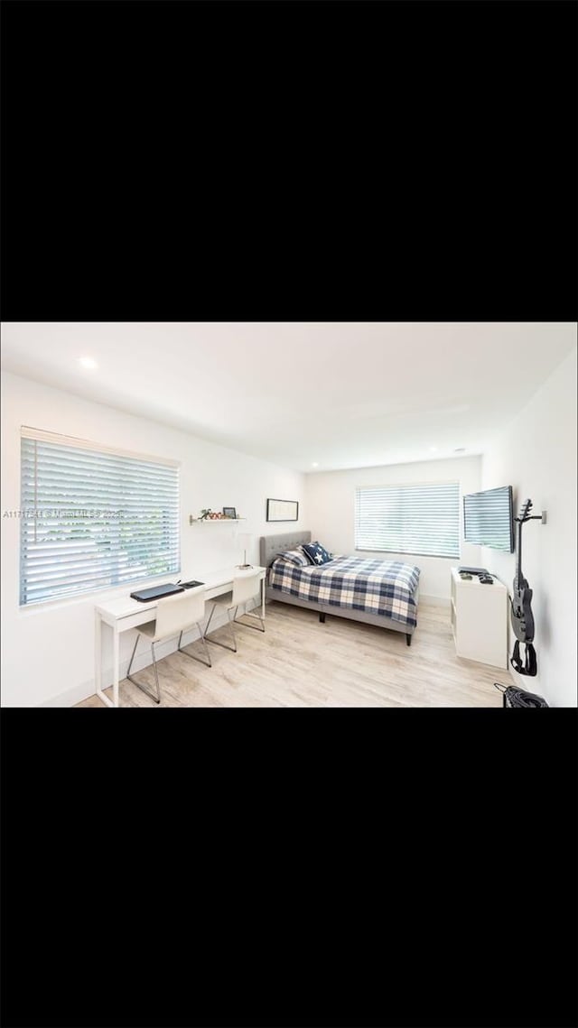 bedroom with light wood-type flooring