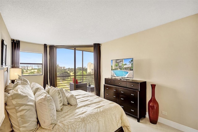 bedroom featuring a textured ceiling and access to outside