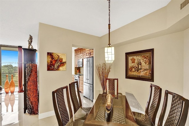 dining area with light tile patterned floors