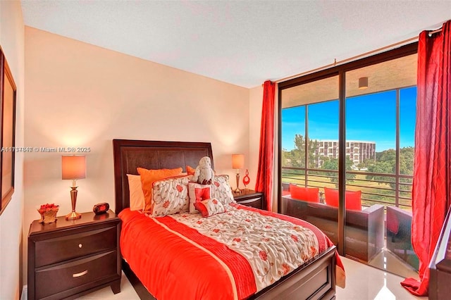 bedroom with access to exterior, a textured ceiling, and floor to ceiling windows