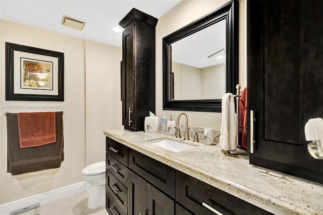 bathroom featuring tile patterned flooring, vanity, and toilet