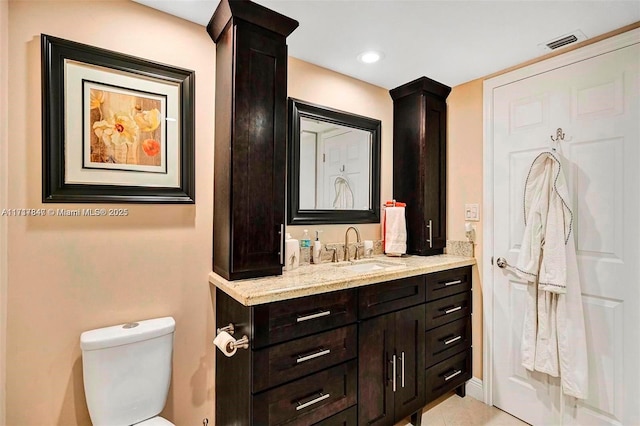 bathroom featuring vanity and toilet