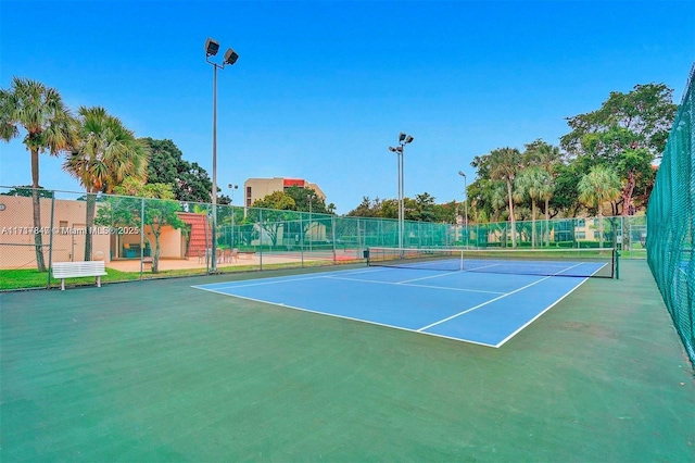 view of tennis court with basketball hoop