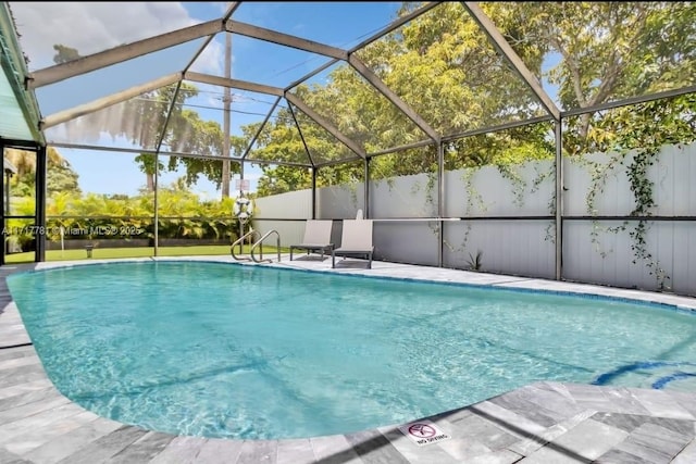 view of pool featuring glass enclosure